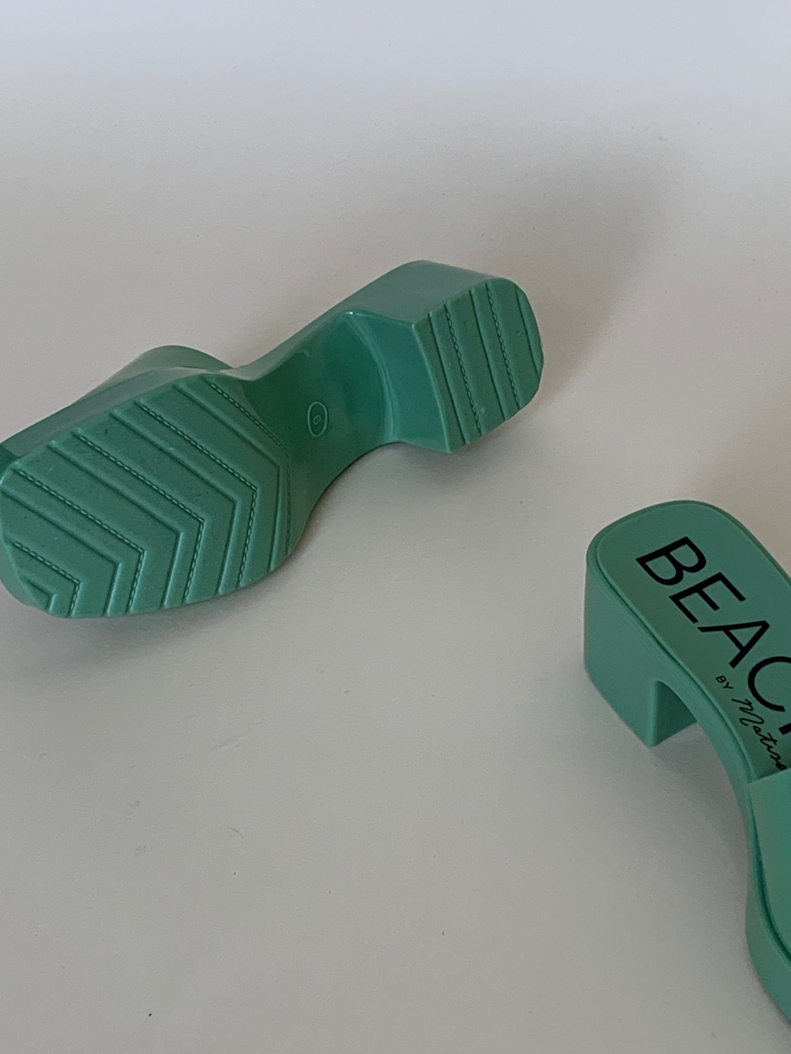 Green plastic sandals