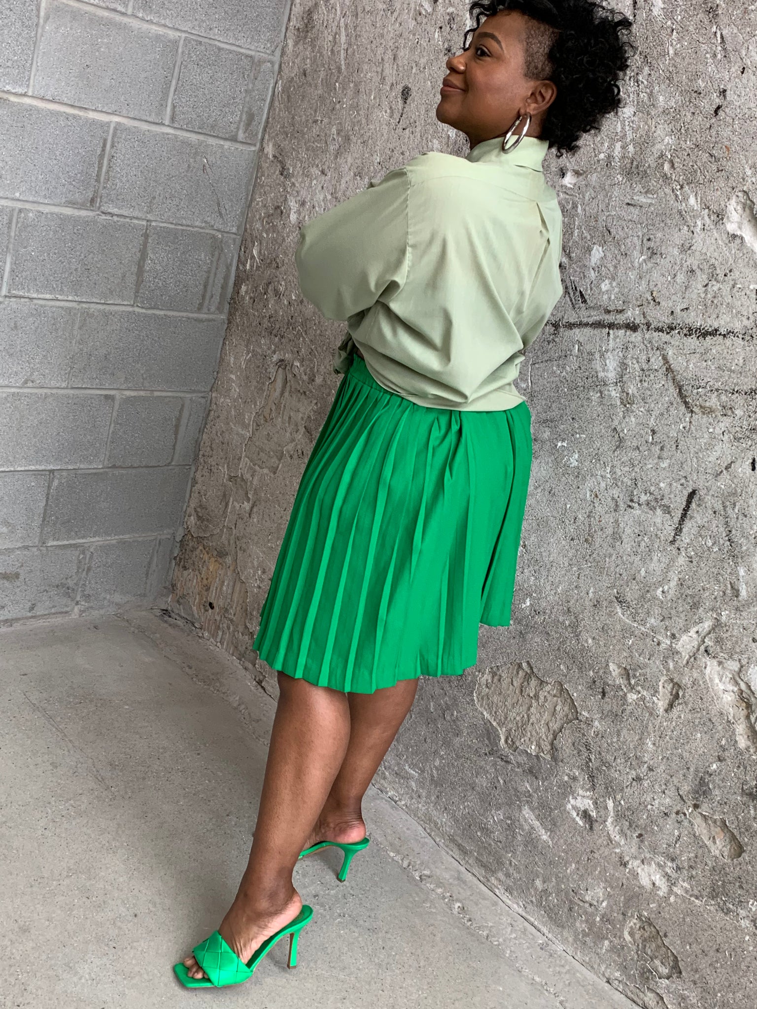 green pleated mini skirt